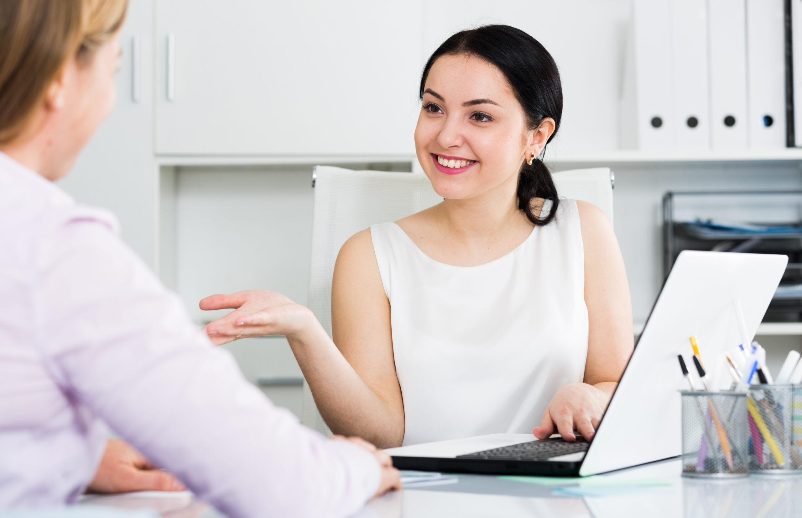 Young female manager meeting woman client in office